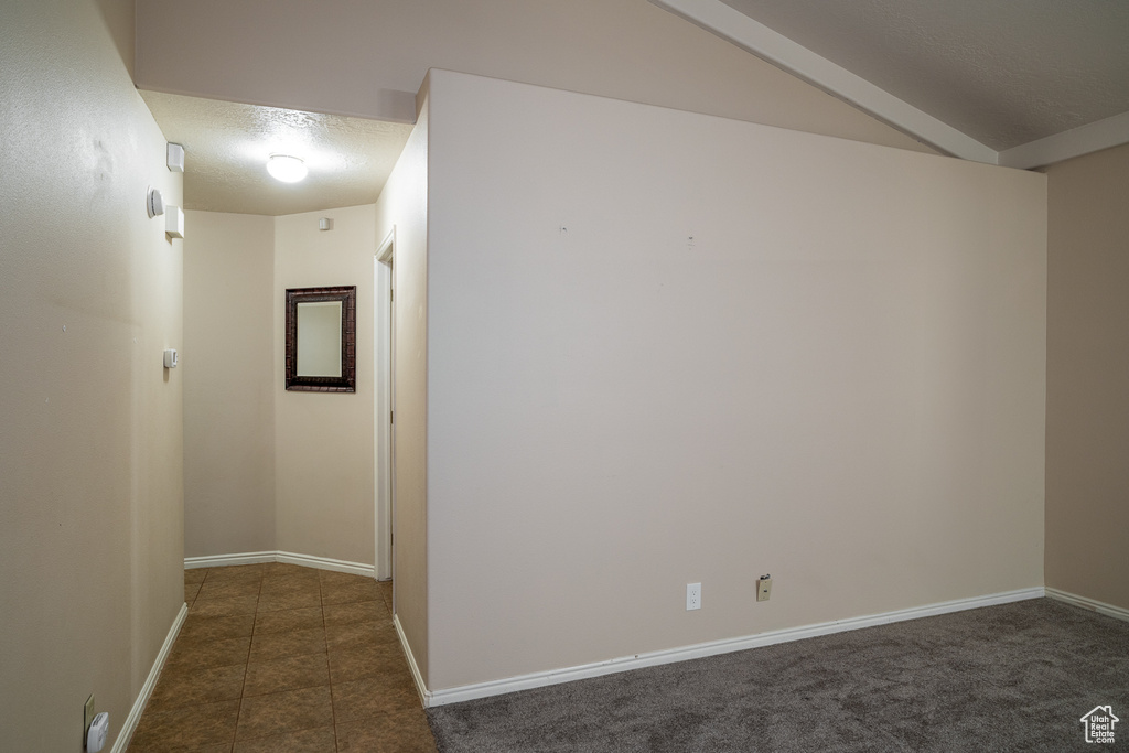 Tiled spare room with baseboards and a textured ceiling