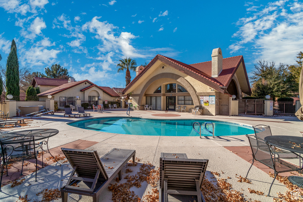 Community pool with a patio
