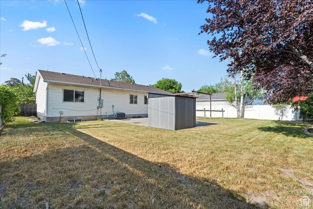 Rear view of property featuring central AC