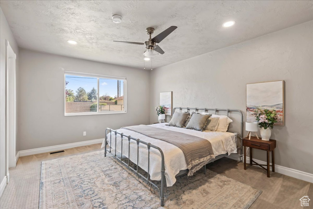 Bedroom featuring baseboards, ceiling fan, recessed lighting, carpet floors, and a textured ceiling