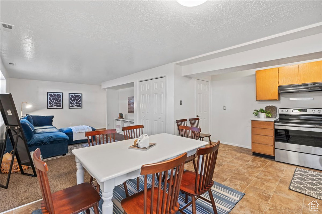 Dining area with a textured ceiling and baseboards