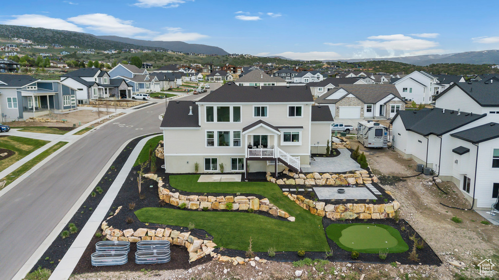 Aerial perspective of suburban area with a mountainous background