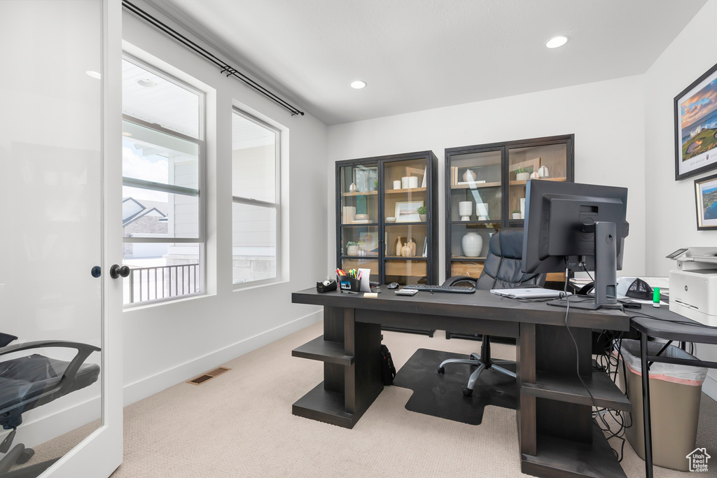 Office with carpet flooring and recessed lighting