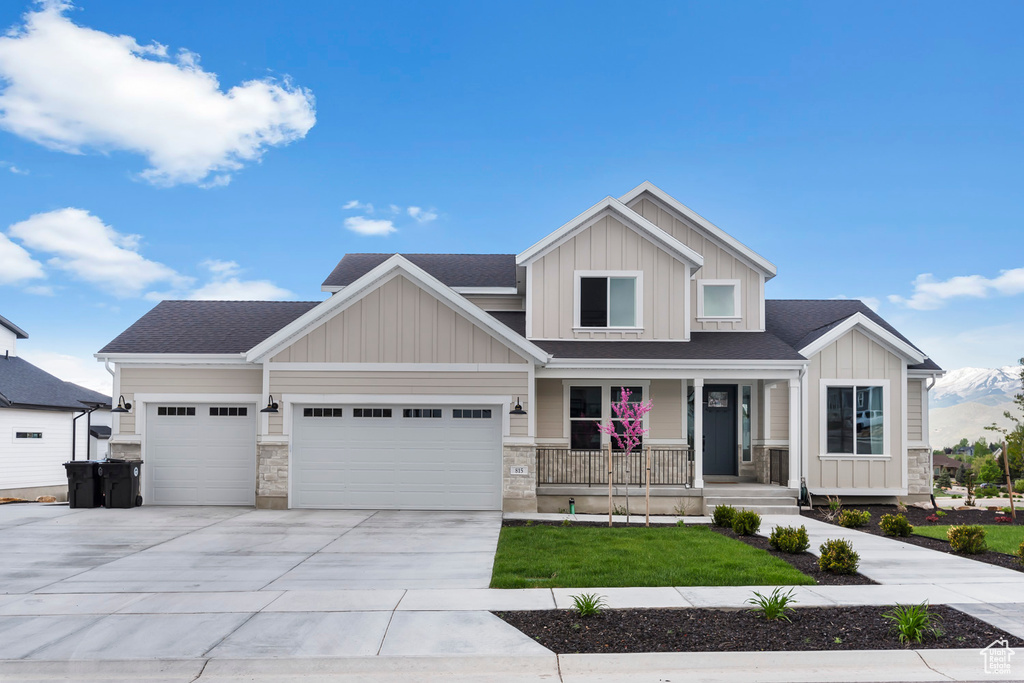 Craftsman-style house with a porch, an attached garage, concrete driveway, and a shingled roof