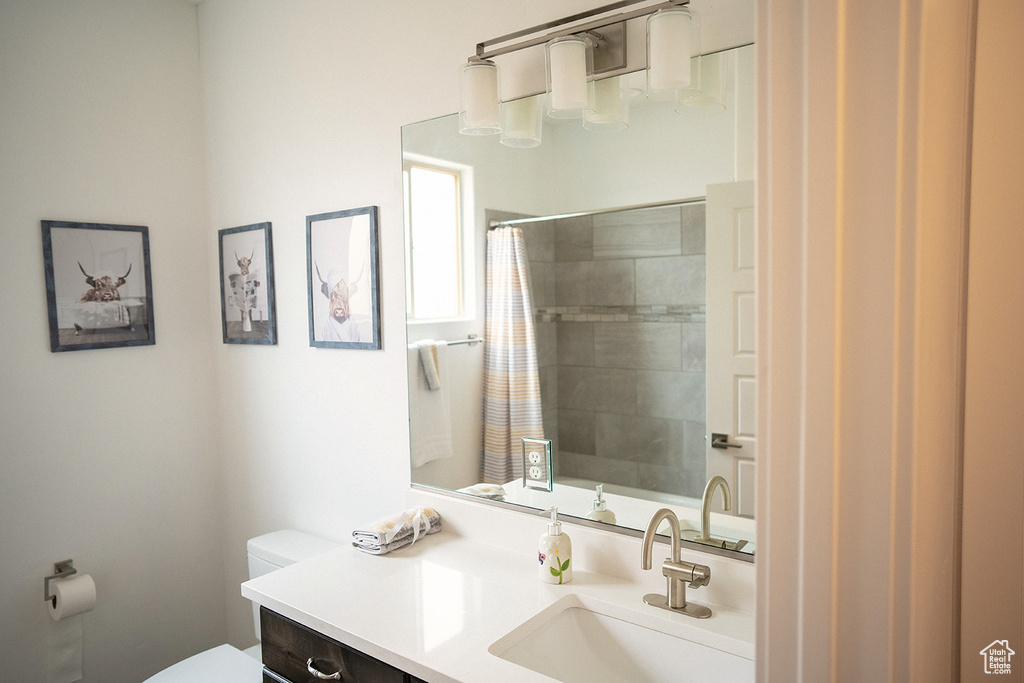 Full bath featuring vanity and curtained shower