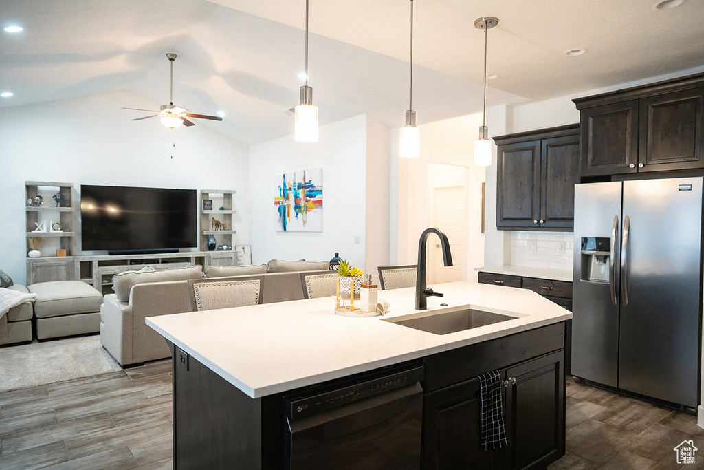 Kitchen featuring stainless steel fridge with ice dispenser, wood finished floors, black dishwasher, light countertops, and a ceiling fan