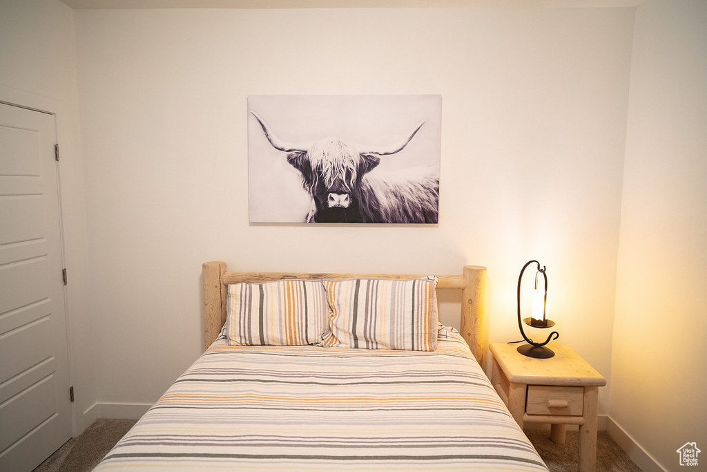 Carpeted bedroom with baseboards