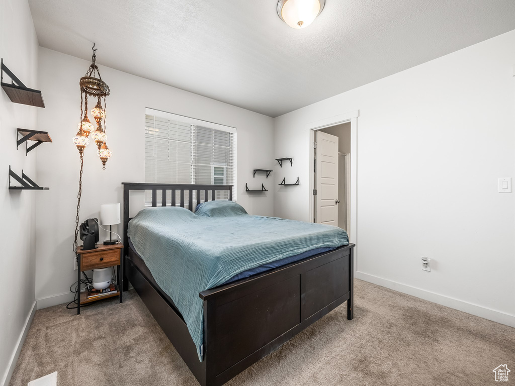 Carpeted bedroom featuring baseboards