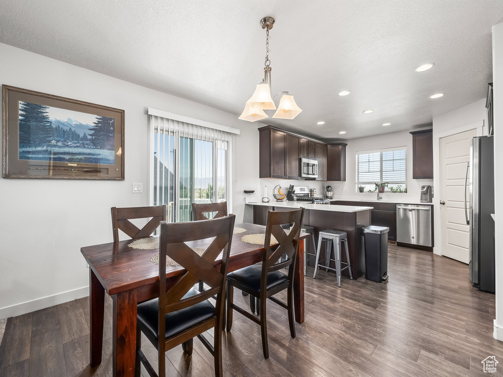 Dining room featuring dark wood-style floors and recessed lighting