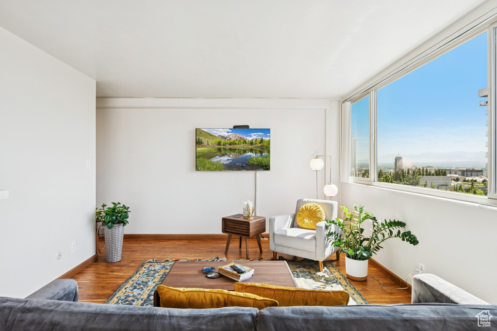 Living area with baseboards and wood finished floors