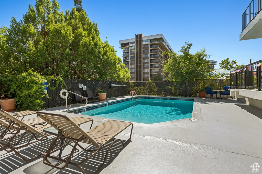Community pool with a patio