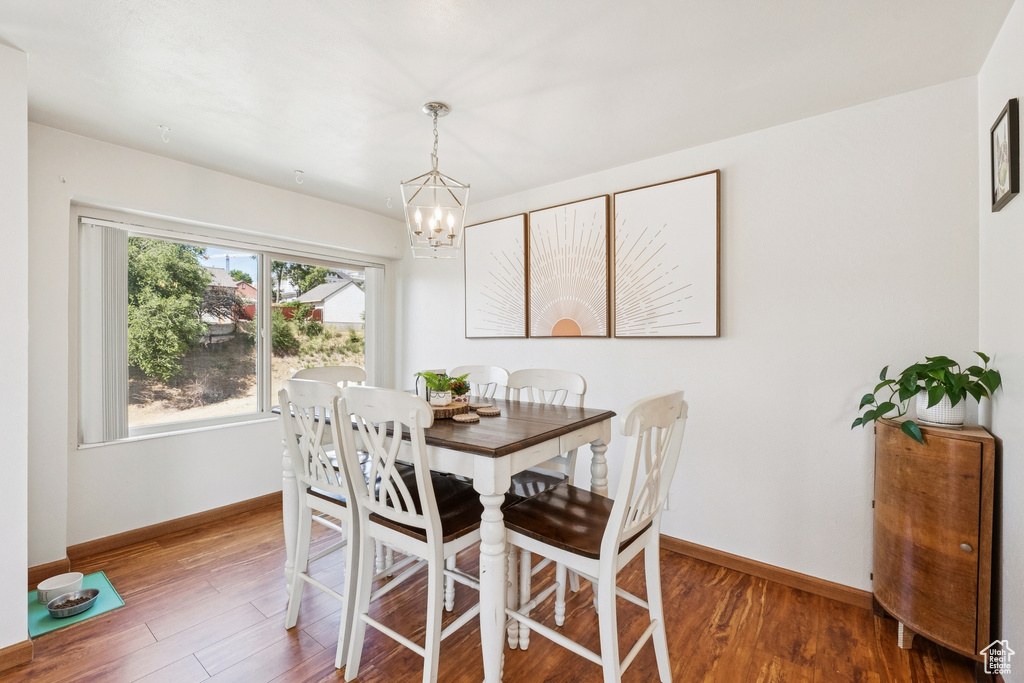 Dining area featuring a chandelier and wood finished floors