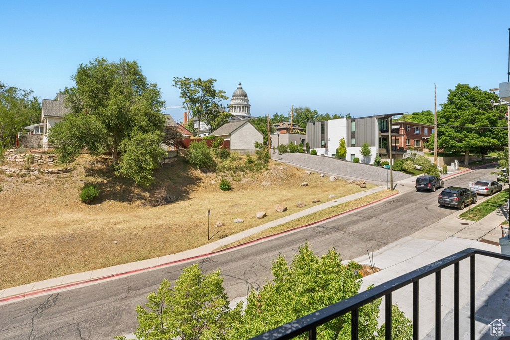 View of asphalt road with sidewalks, curbs, and a residential view