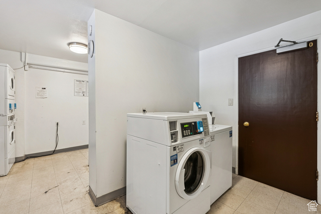 Community laundry room with washer and dryer and stacked washer and clothes dryer