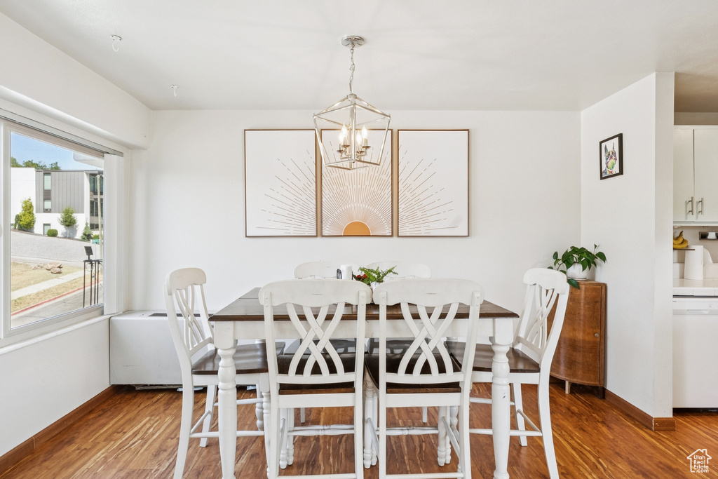 Dining area featuring wood finished floors and a chandelier