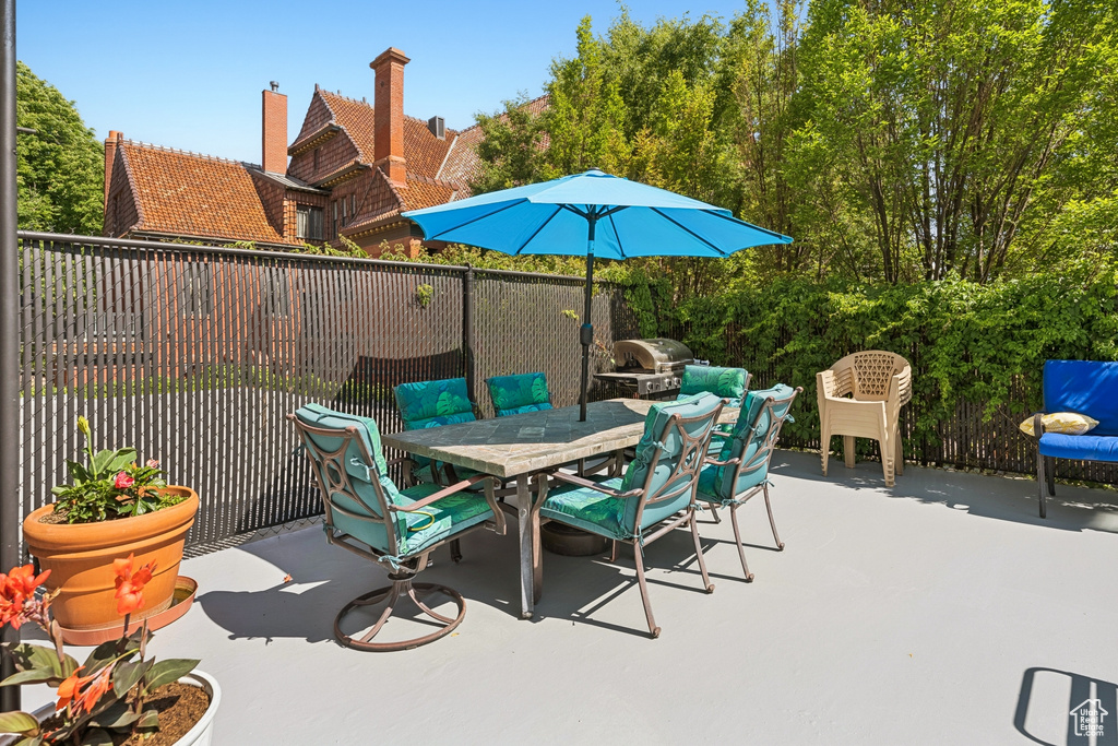 View of patio with area for grilling and outdoor dining area