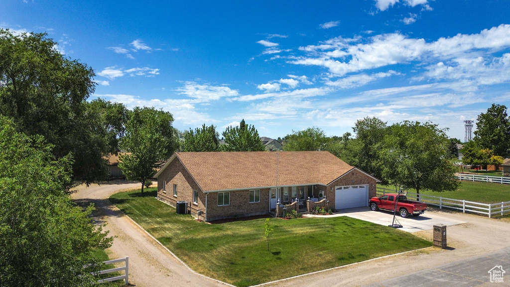 Single story home with driveway, brick siding, and a garage