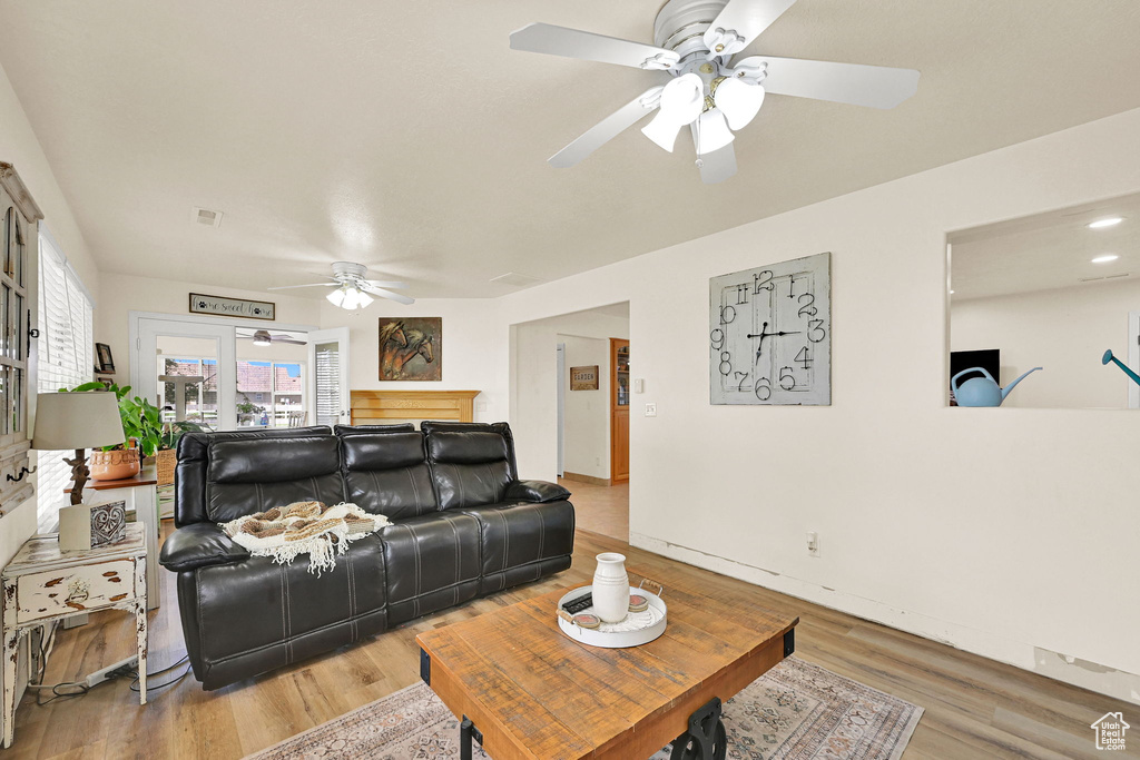 Living area featuring a ceiling fan and wood finished floors