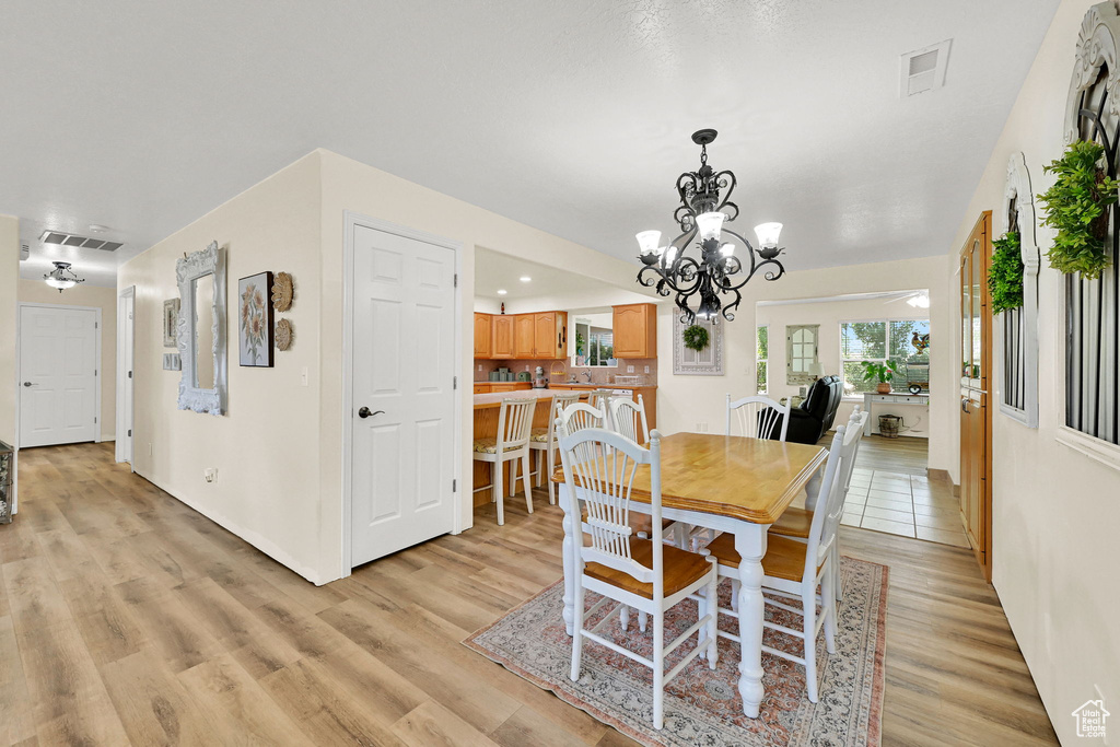 Dining room with a chandelier and light wood finished floors