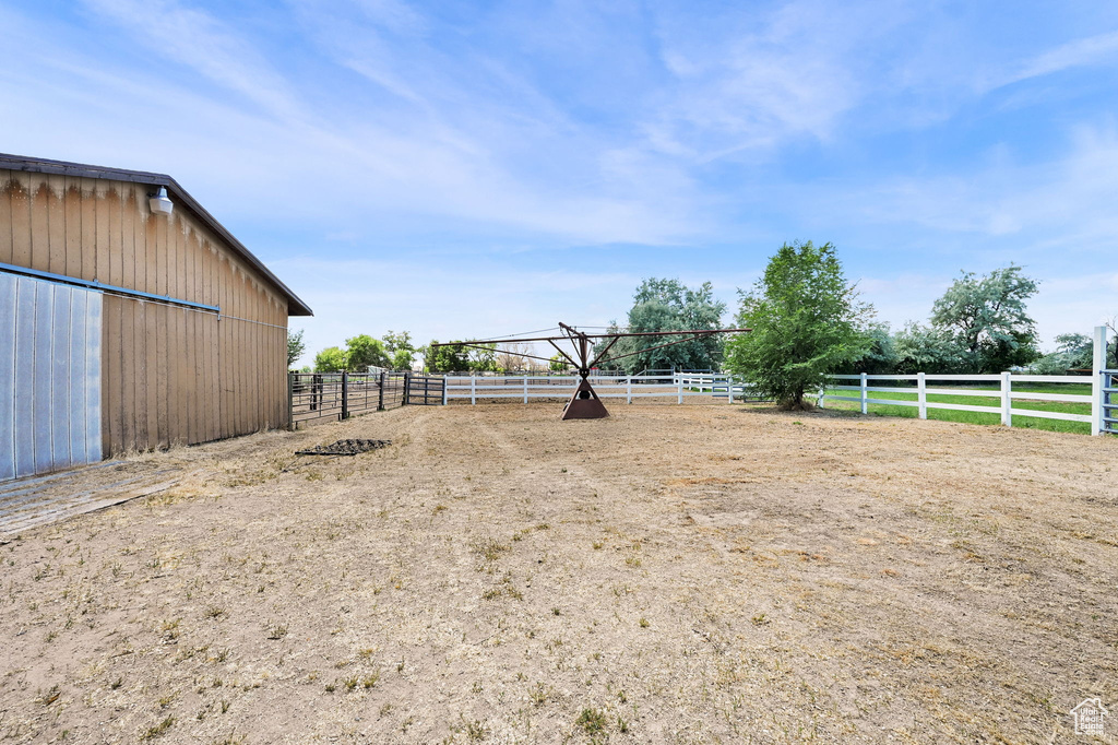 View of yard with an enclosed riding area and a view of countryside