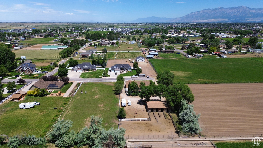 Aerial view of property and surrounding area featuring a mountain backdrop