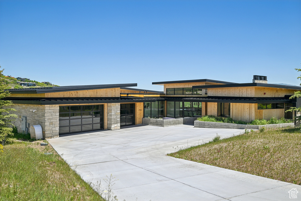Contemporary home featuring concrete driveway