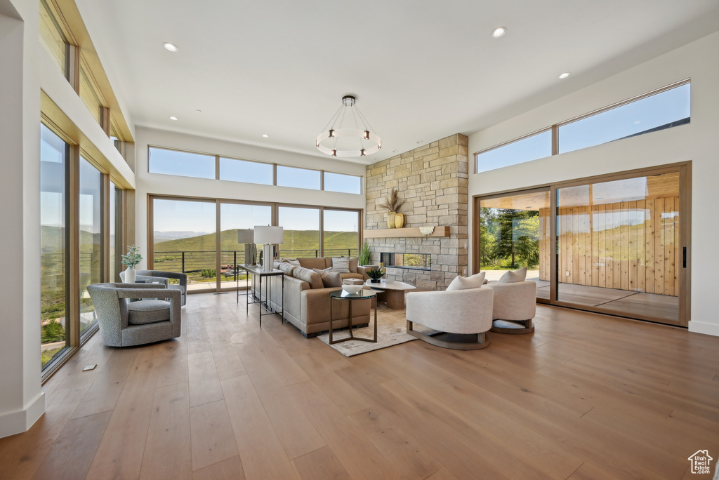 Living room featuring plenty of natural light, a fireplace, hardwood / wood-style floors, and recessed lighting