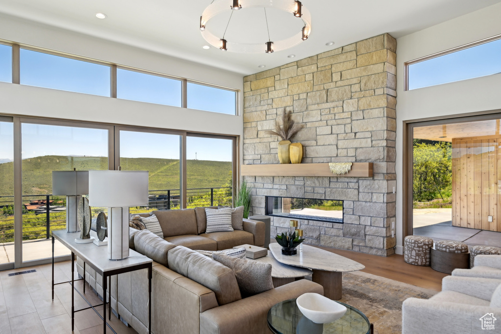 Living room with a stone fireplace and a high ceiling