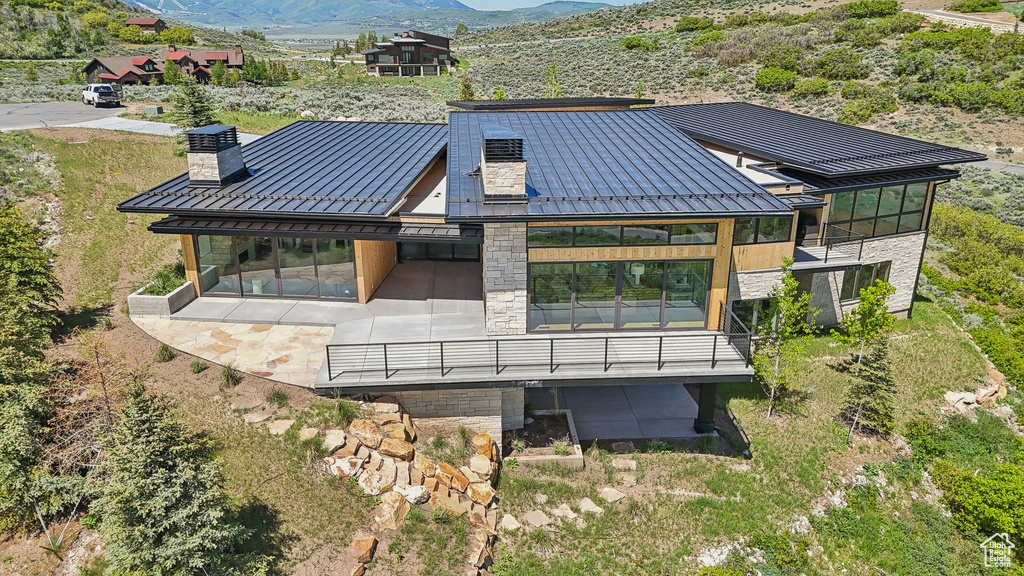Aerial view of property and surrounding area featuring mountains