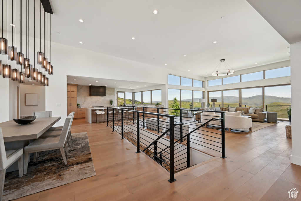 Dining area with plenty of natural light, a chandelier, light wood-style floors, and recessed lighting