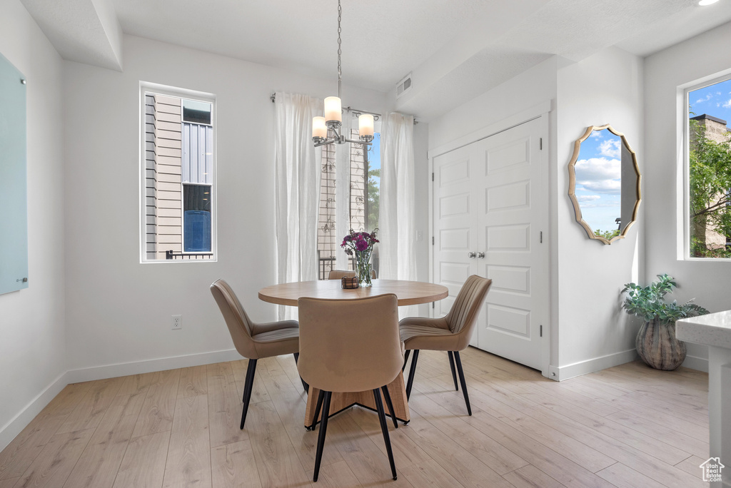 Dining room featuring a chandelier and light wood-type flooring