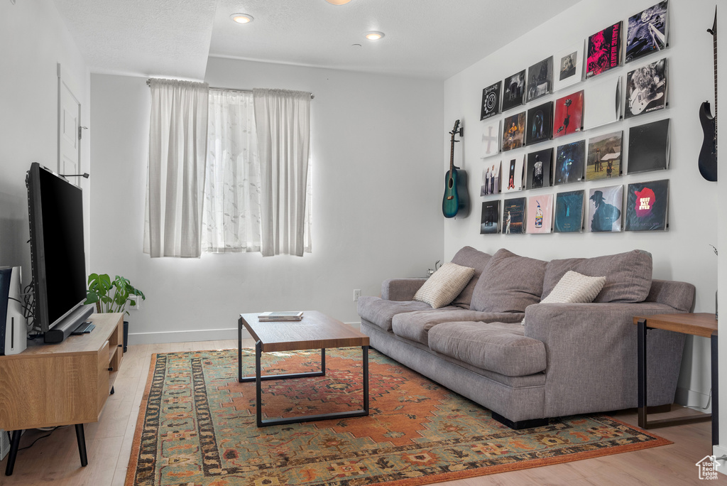Living room with recessed lighting and wood finished floors