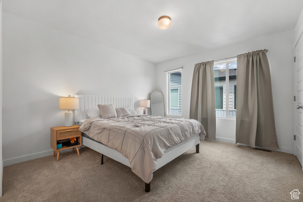 Carpeted bedroom featuring baseboards