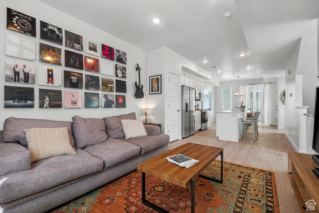 Living room featuring light wood-style floors and recessed lighting