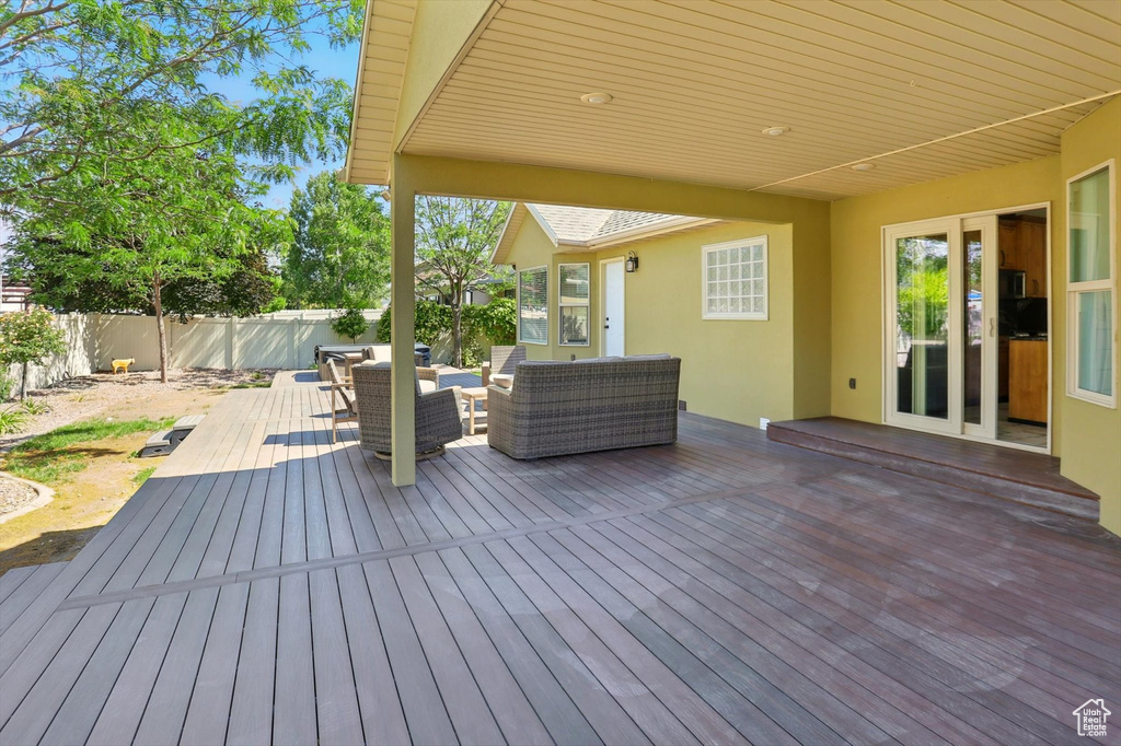 Deck featuring outdoor lounge area and a fenced backyard