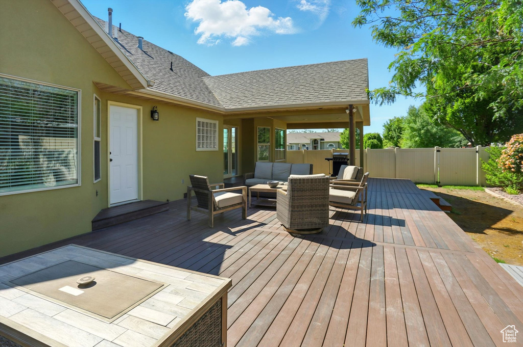 Wooden deck featuring an outdoor living space