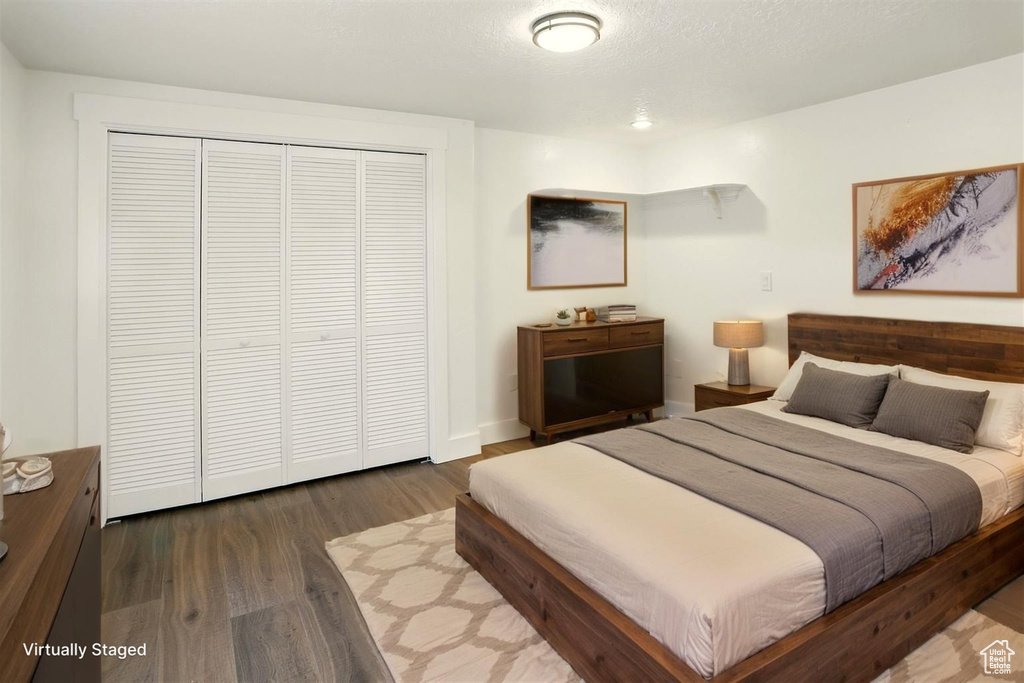 Bedroom featuring wood finished floors and a closet
