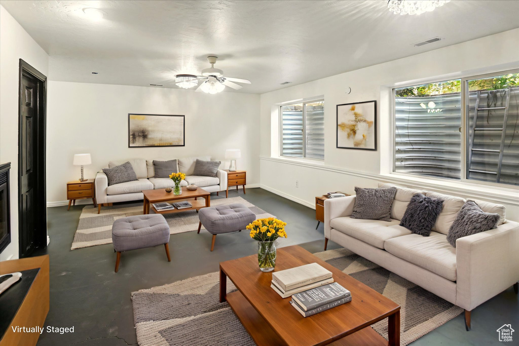 Living area with a ceiling fan and carpet
