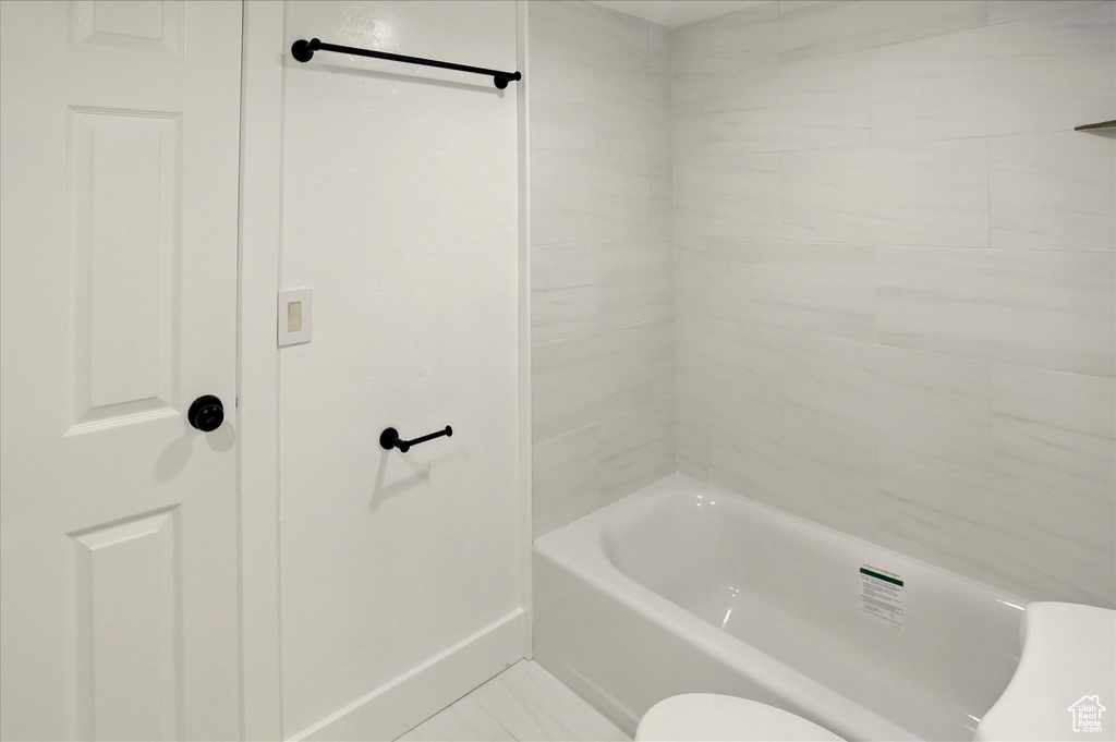 Full bathroom with toilet and  shower combination