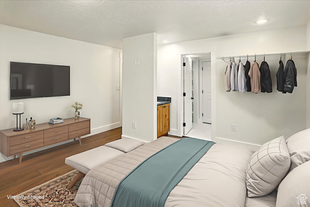 Bedroom with wood finished floors and recessed lighting