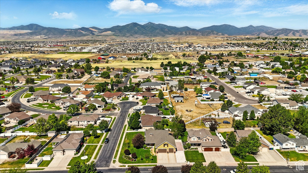 Aerial view of property's location featuring mountains and nearby suburban area