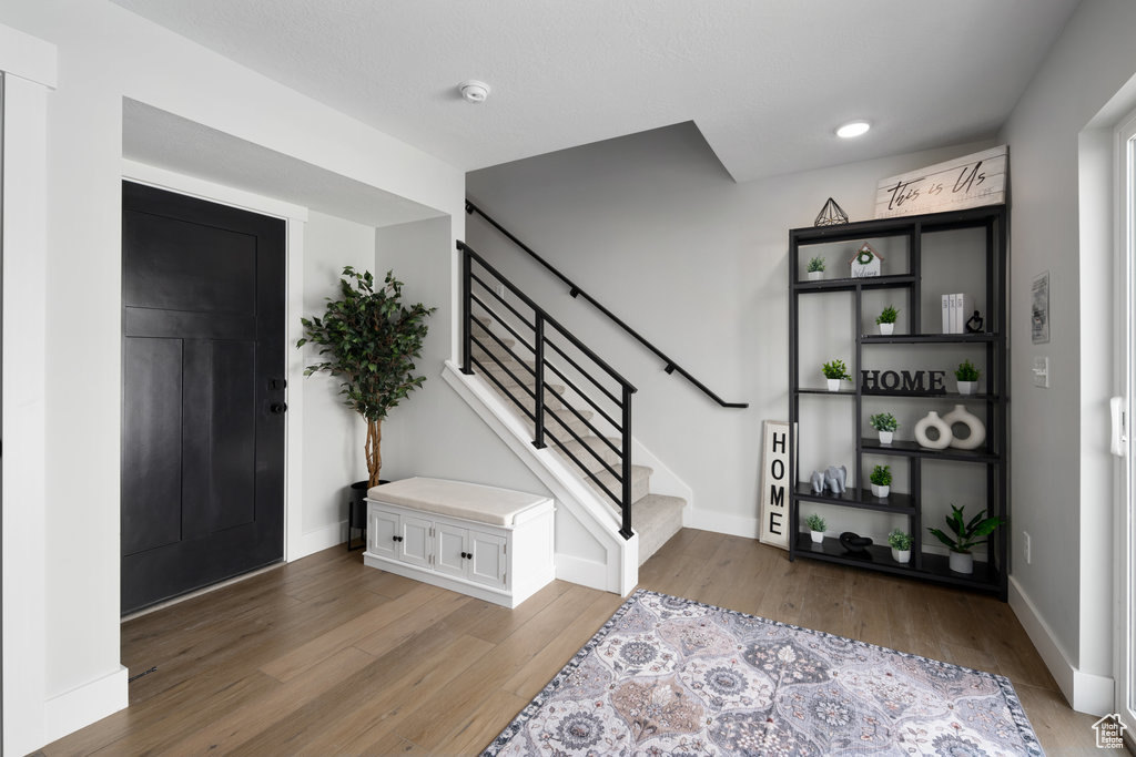 Foyer entrance featuring light wood-type flooring and stairway