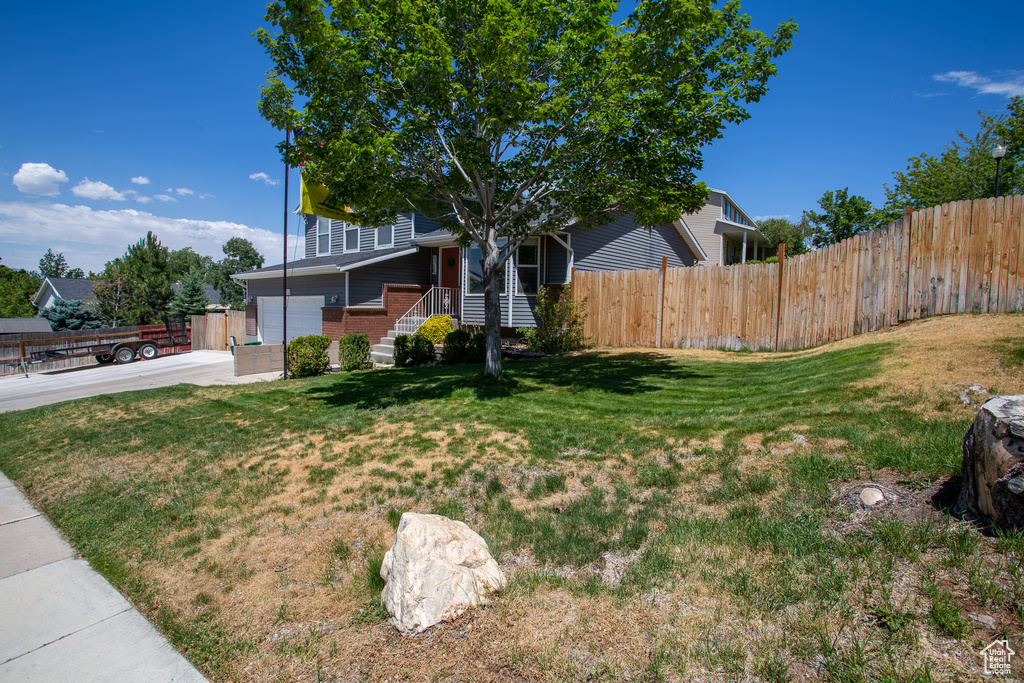 View of front of home with brick siding and a garage