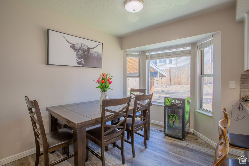 Dining space featuring wood finished floors and baseboards