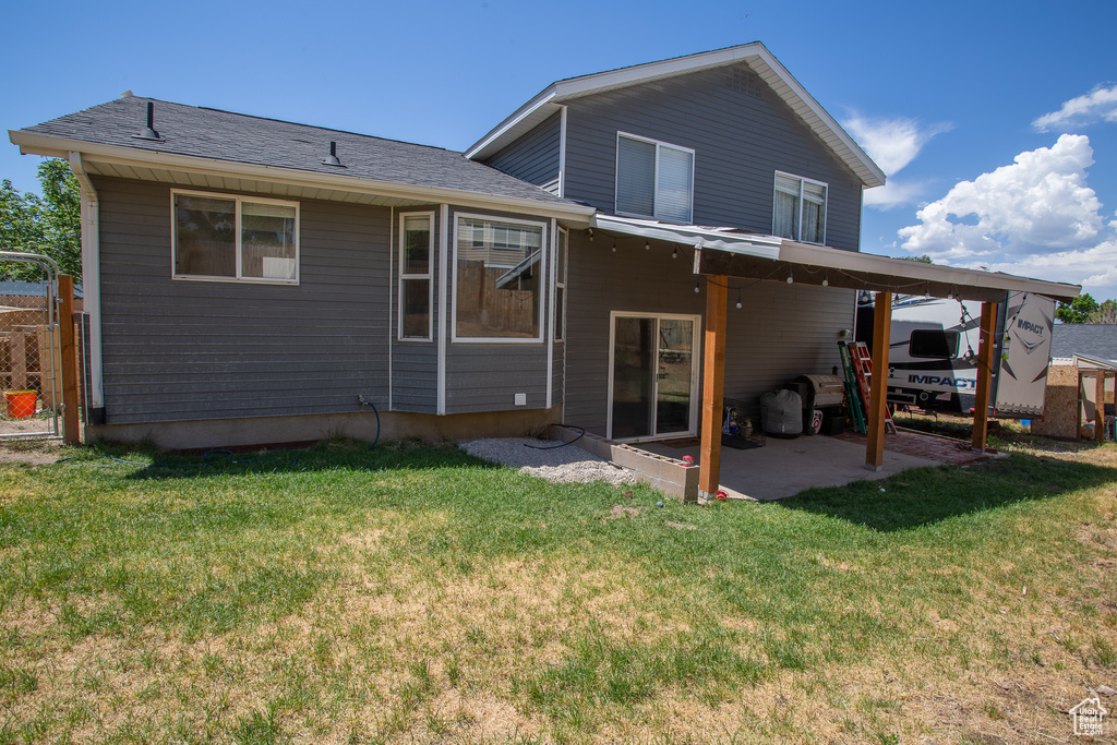 Back of house featuring a patio and a gate