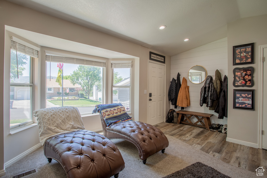 Sitting room featuring lofted ceiling, plenty of natural light, wood finished floors, and recessed lighting