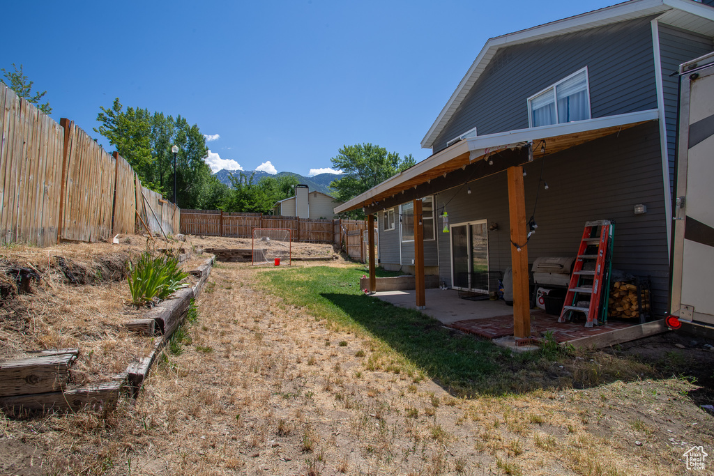 Fenced backyard with a patio and a mountain view