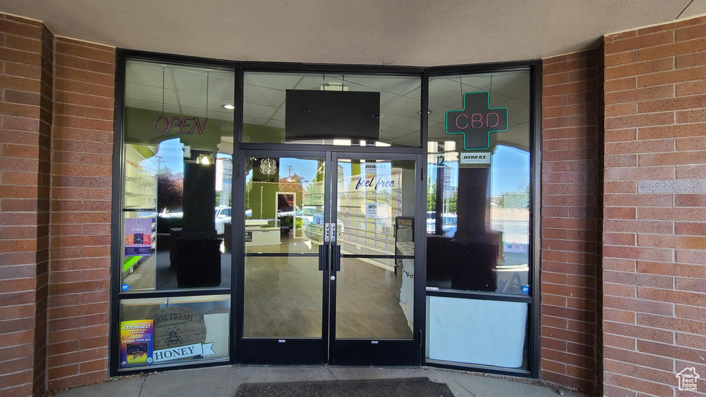 Property entrance featuring brick siding