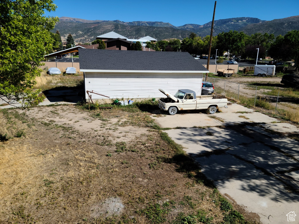 View of side of home with a mountain view