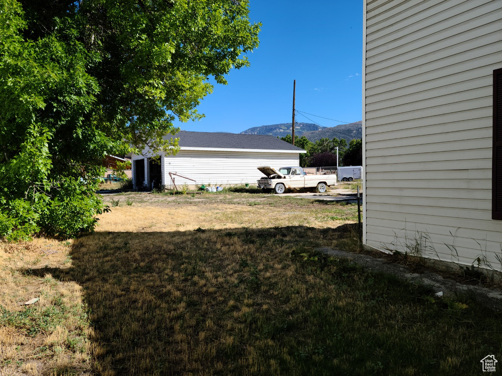 View of grassy yard with a mountain view